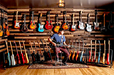Dillon Taylor with his Guitar Collection at Dillon's Garage