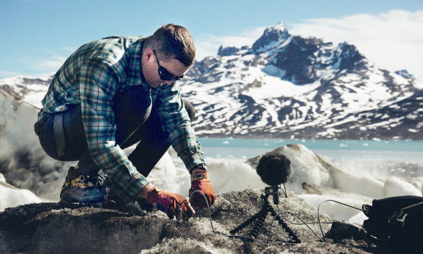 Thomas Beverly setting up a microphone with Bubblebee wind protection in East Greenland.
