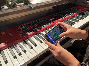 Lakewood Music Institute Director/Keyboardist Kim Stice makes a quick adjustment to her IEM mix via Klang:app on her phone