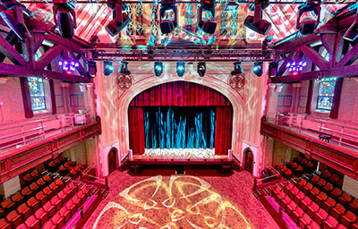 White L-Acoustics Syva and Syva Low flank the Scotty’s stage, with two X12 as near-balcony side fill and two X8 as under-balcony side fill