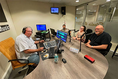 Brian Emmenis (left) with GoldFM station staff