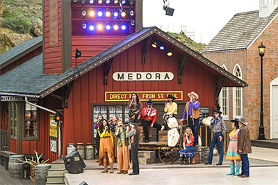 Medora Musical performers on stage at the foot of the stage-right tower building