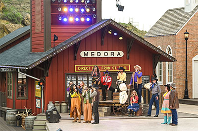 Medora Musical performers on stage at the foot of the stage-right tower building