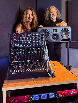 Starr Parodi and Jeff Fair, pictured with some of their newly acquired gear (including monitors from ADAM Audio and Focusrite interfaces), serving as a replacement setup for their gear lost in the wildfires earlier this year